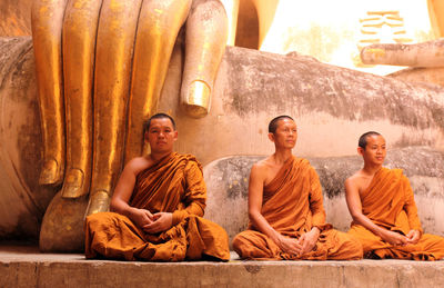 Group of people sitting on wood