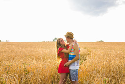 Woman standing on agricultural field against sky