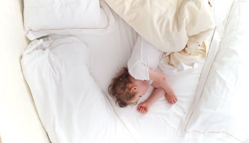 Cute baby sleeping on bed