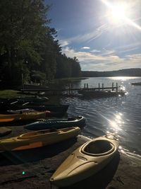 Boats in river during sunset