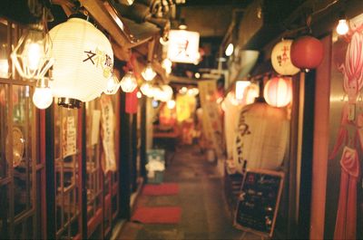 Illuminated chinese lanterns hanging outside stores