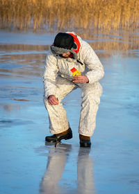 Landscape with ice fishing on a frozen lake, winter sport, outdoor recreation	