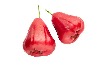 Close-up of water apples over white background