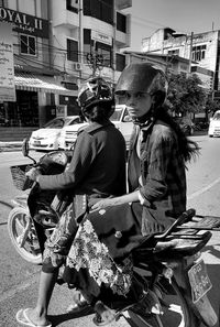 Women sitting on street in city