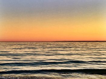 Scenic view of sea against clear sky during sunset