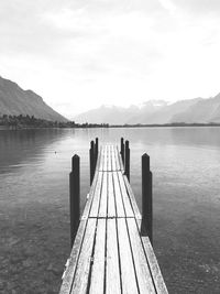 Pier over lake against sky