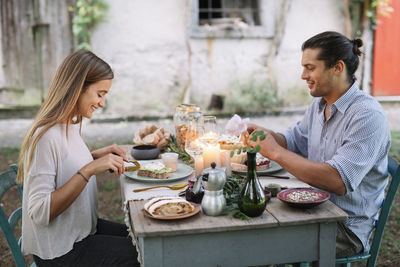 Young couple sitting on table