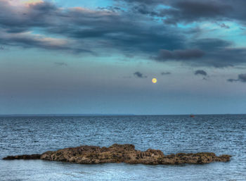 Scenic view of sea against sky at dusk