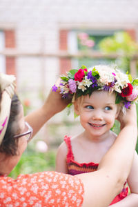 Portrait of smiling girl with pink flower