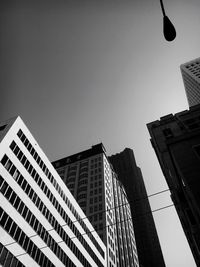 Low angle view of skyscrapers against clear sky