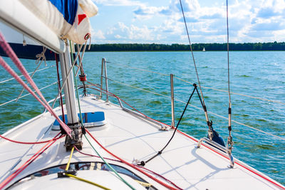 Sailboat sailing in sea against sky