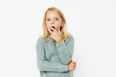 Portrait of girl standing against white background