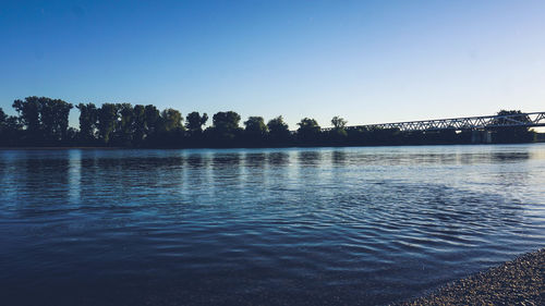 Scenic view of lake against clear blue sky