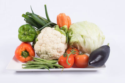 Close-up of fresh vegetables against white background