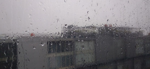 Raindrops on glass window during rainy season