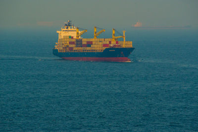 Ship sailing on sea against sky