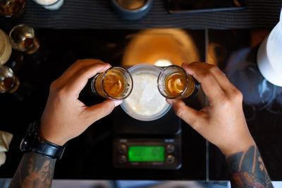 Midsection of man holding coffee glass