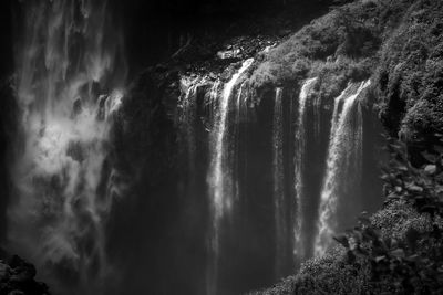 Scenic view of waterfall against sky