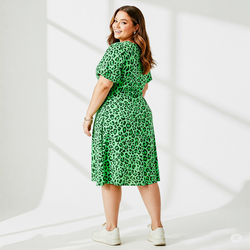 Full length of young woman standing against wall