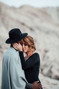 Couple embracing while standing at desert