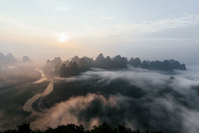 Mountain peaks under sky at sunrise, guilin, china