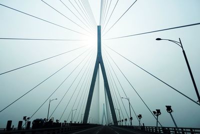 Low angle view of suspension bridge against sky