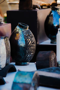 Close-up of old bottles on table at market