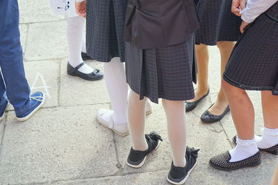 Low section of people standing on footpath