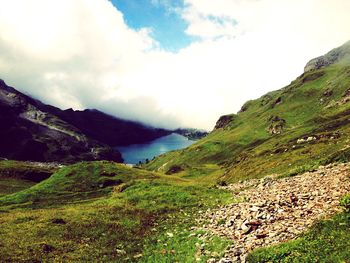 Scenic view of mountains against cloudy sky