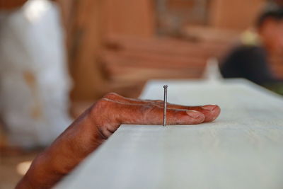 Cropped hand of carpenter working in workshop