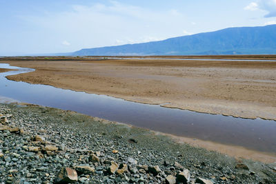 Scenic view of lake natron against sky on a sunny day in rural tanzania
