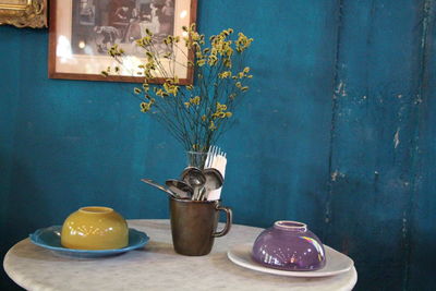 Potted plant on table against wall