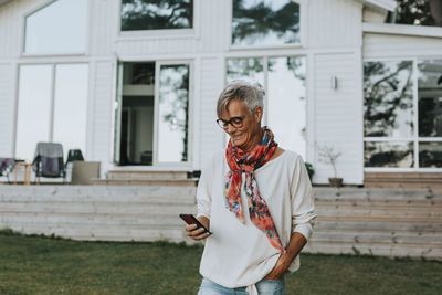 Smiling woman using cell phone