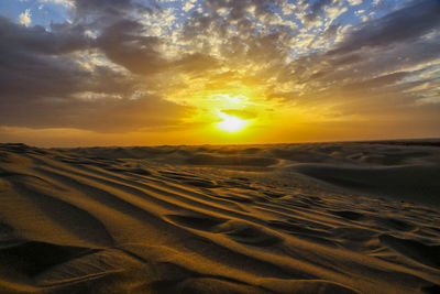Tranquil view of desert at sunset
