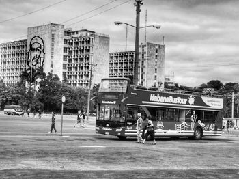 People on city street against sky