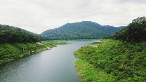 Scenic view of river amidst mountains against sky