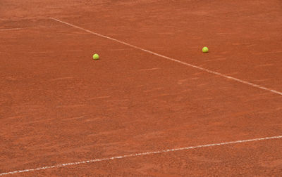 Yellow balls on tennis court