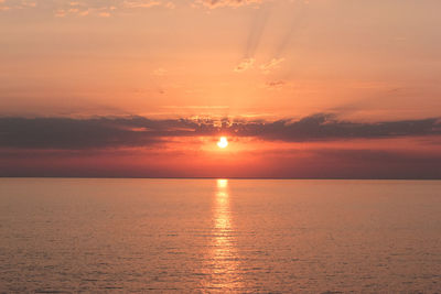 Scenic view of sea against romantic sky at sunset