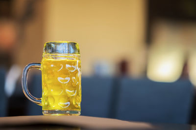 Close-up of pint glass on table in bar