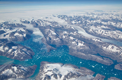 Aerial view of snowcapped mountains against sky