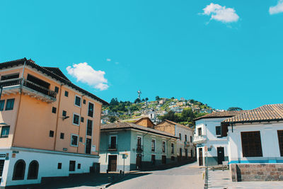 Exterior of buildings in town against blue sky