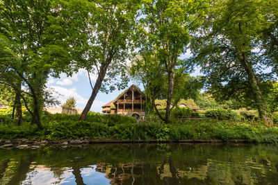 Scenic view of lake by trees and building