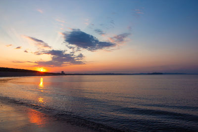 Scenic view of sea against romantic sky at sunset