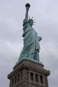 Low angle view of statue against cloudy sky