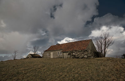 Houses against cloudy sky