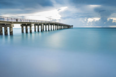 Pier over sea against sky