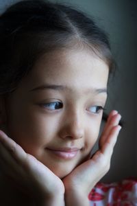 Close-up of cute girl looking away