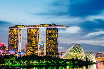 Illuminated buildings against sky in city