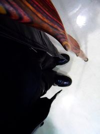 Close-up of woman standing on tiled floor