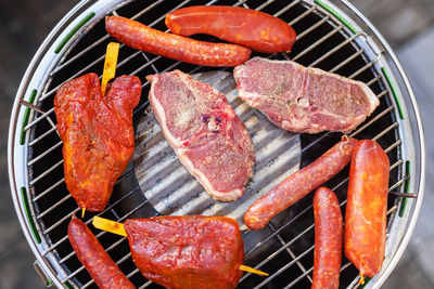 High angle view of meat on barbecue grill